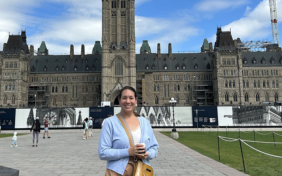 Canadian Friends Service Committee's Government Relations Representative Sandra Wiens stands in front of Parliament Hill